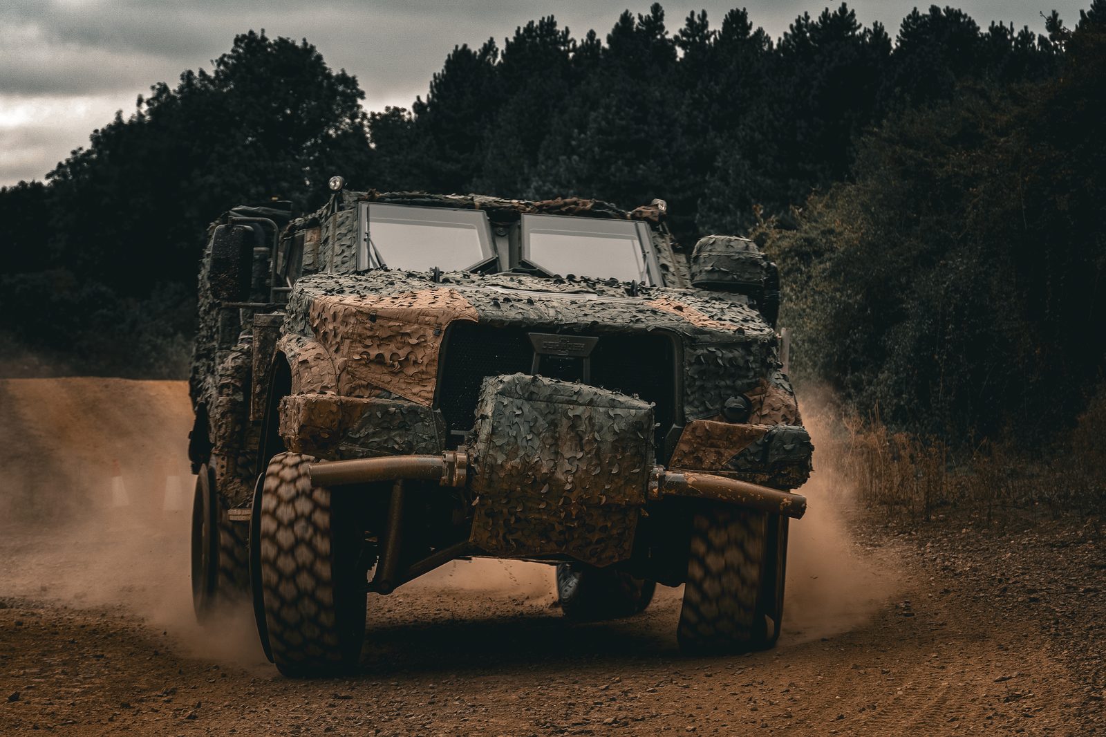 Camouflaged tactical vehicle off road