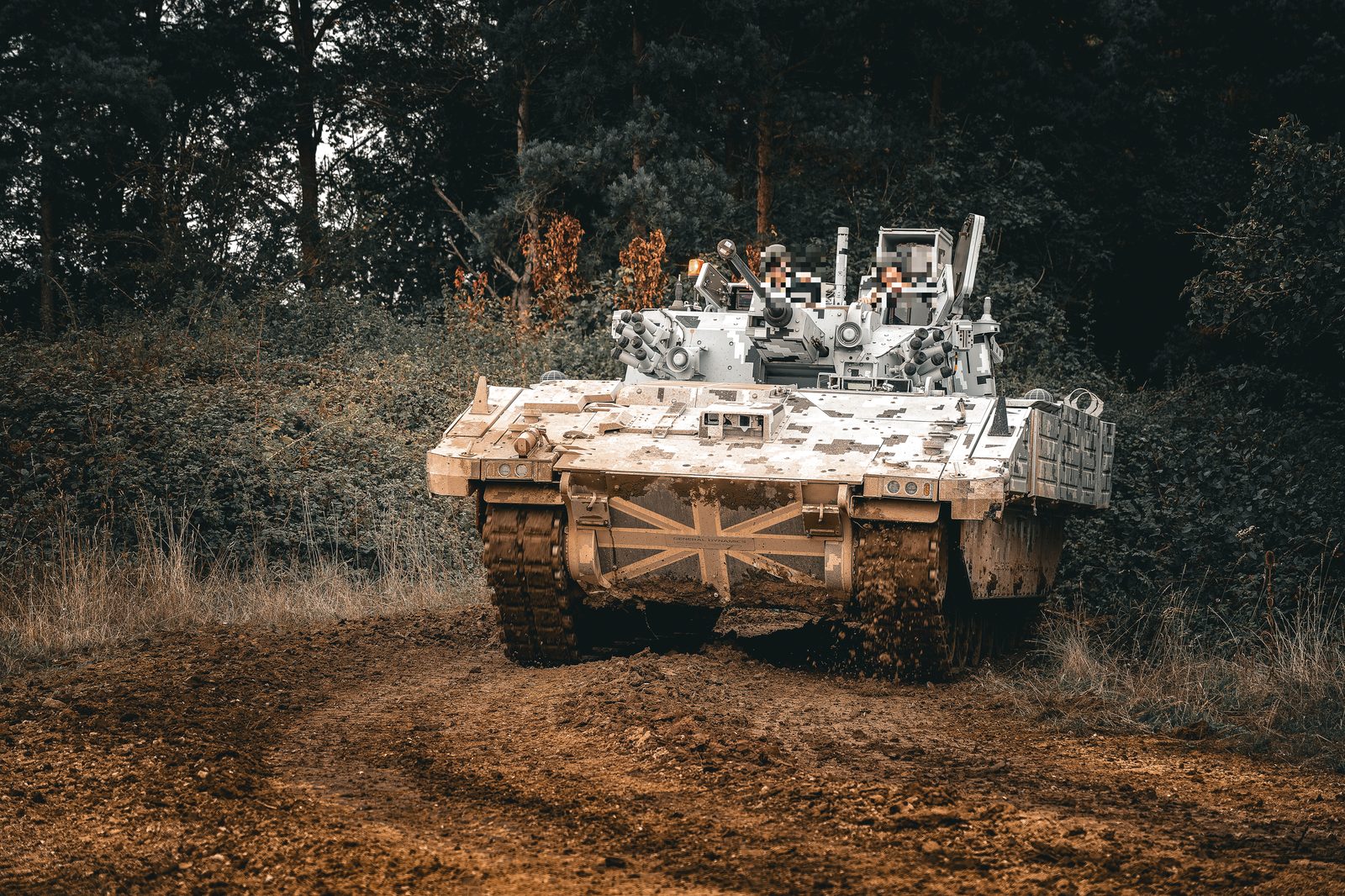 Armoured vehicle crossing deep mud during trials